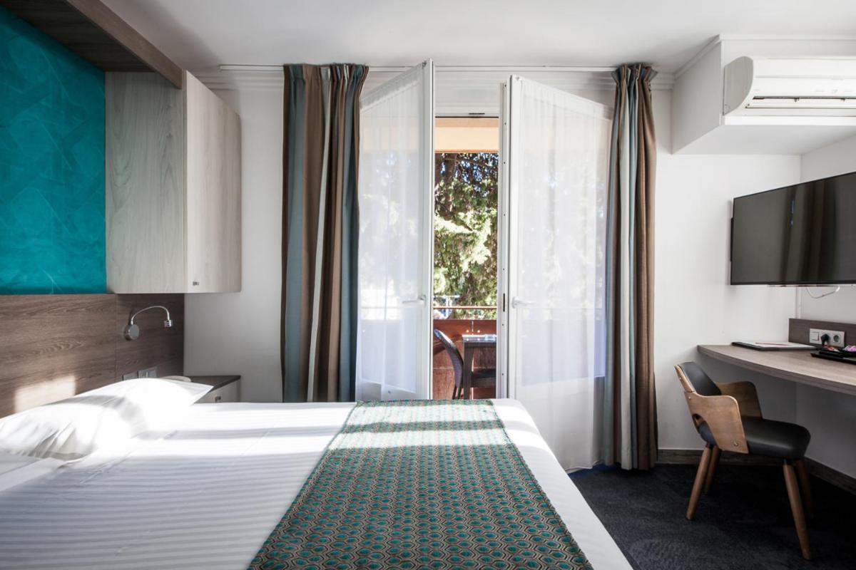 Un ou plusieurs lits dans un hébergement de l'établissement Hotel SPA Plage St Jean