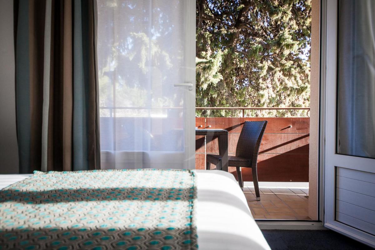 Un ou plusieurs lits dans un hébergement de l'établissement Hotel SPA Plage St Jean