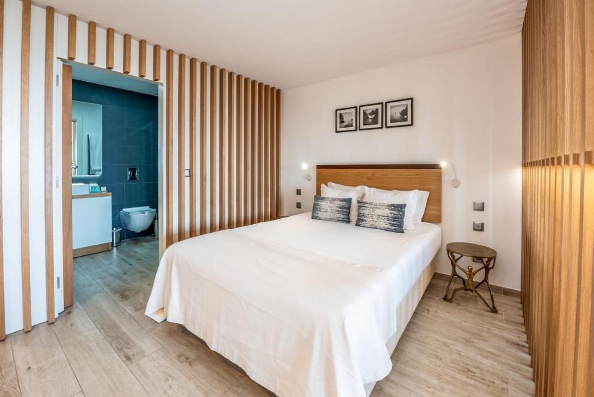 Uma cama ou camas num quarto em Estrela da Luz Resort