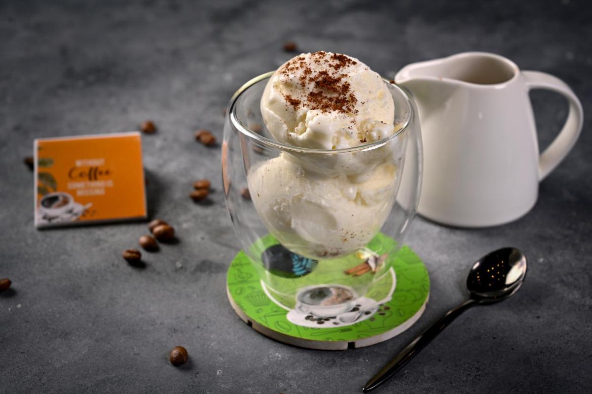a cup of ice cream on a plate with a cup of coffee at Novotel Kolkata Hotel and Residences in Kolkata a cup of ice cream on a plate with a cup of coffee at Novotel Kolkata Hotel and Residences in Kolkata