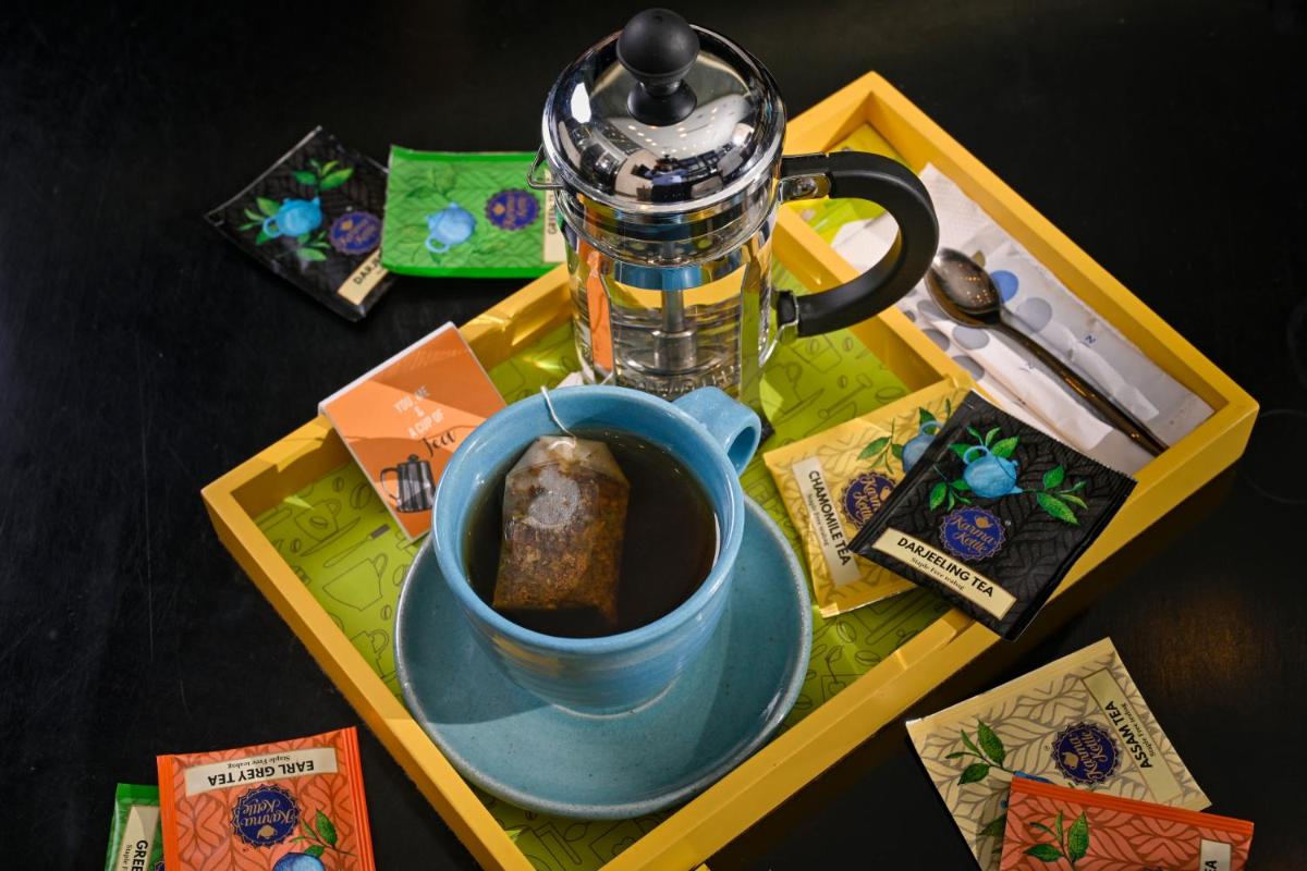 a table with a cup of coffee and a blender at Novotel Kolkata Hotel and Residences in Kolkata a table with a cup of coffee and a blender at Novotel Kolkata Hotel and Residences in Kolkata