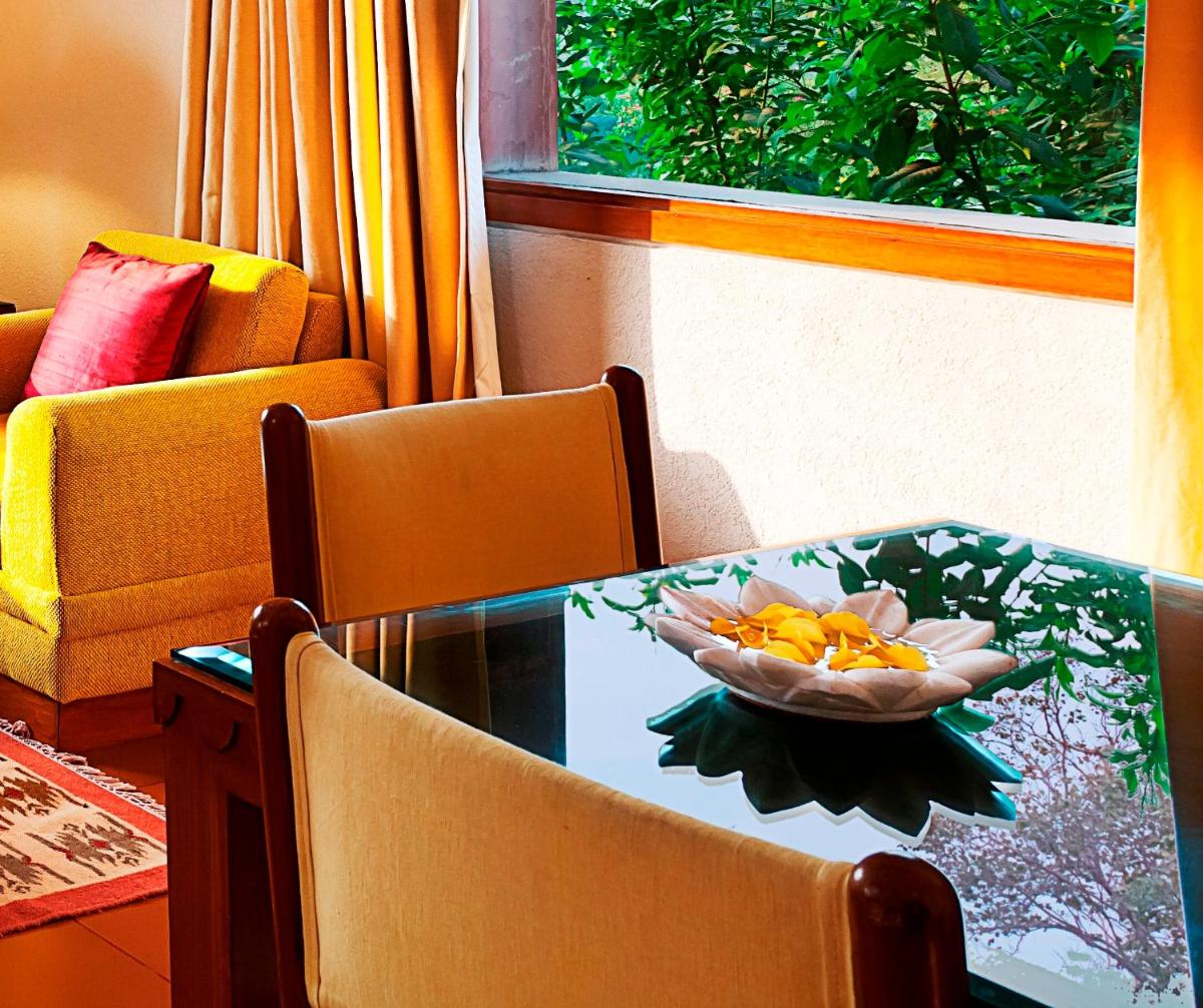 a table with a bowl of fruit on top of it at Trident Agra in Agra
