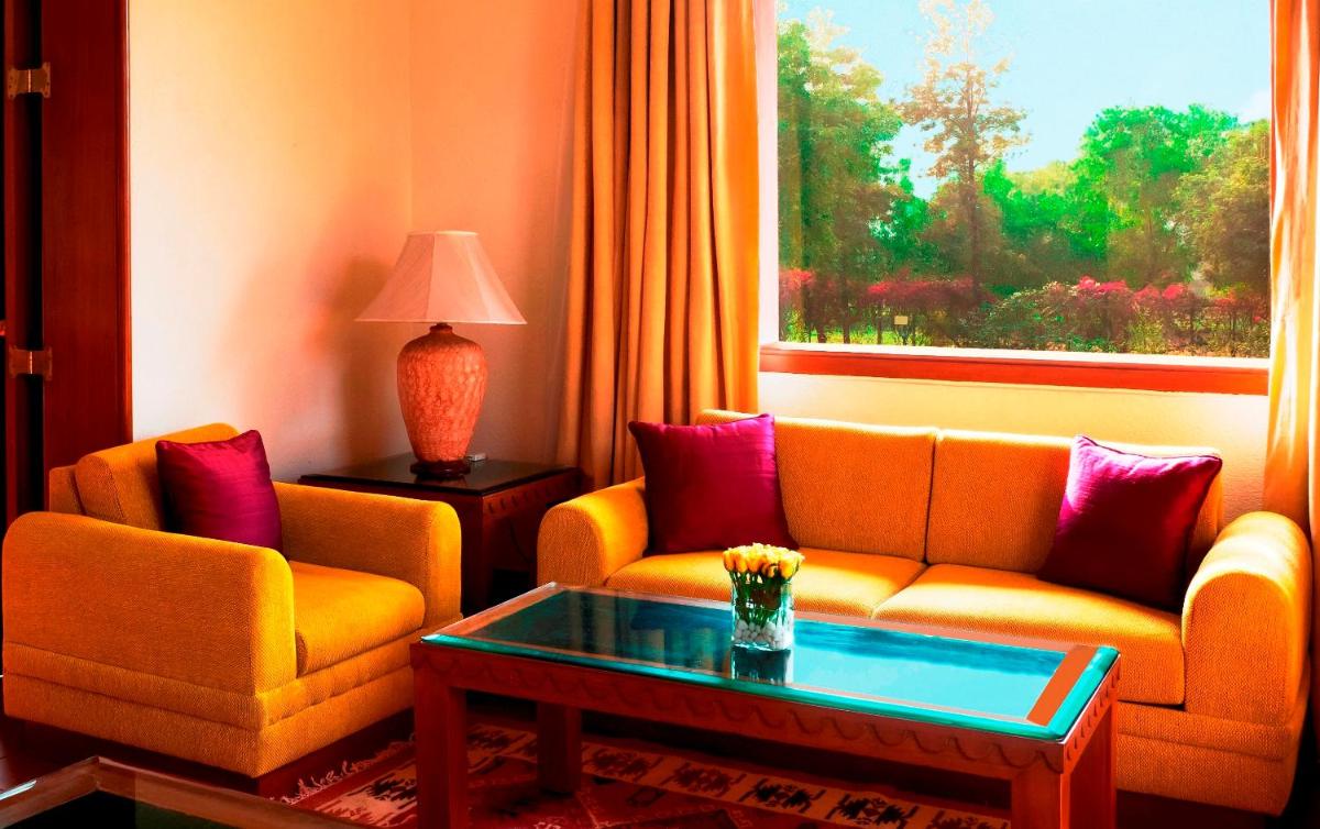 a living room with two couches and a window at Trident Agra in Agra