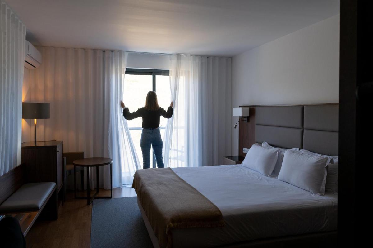 Uma cama ou camas num quarto em Hotel Freixo Douro Superior