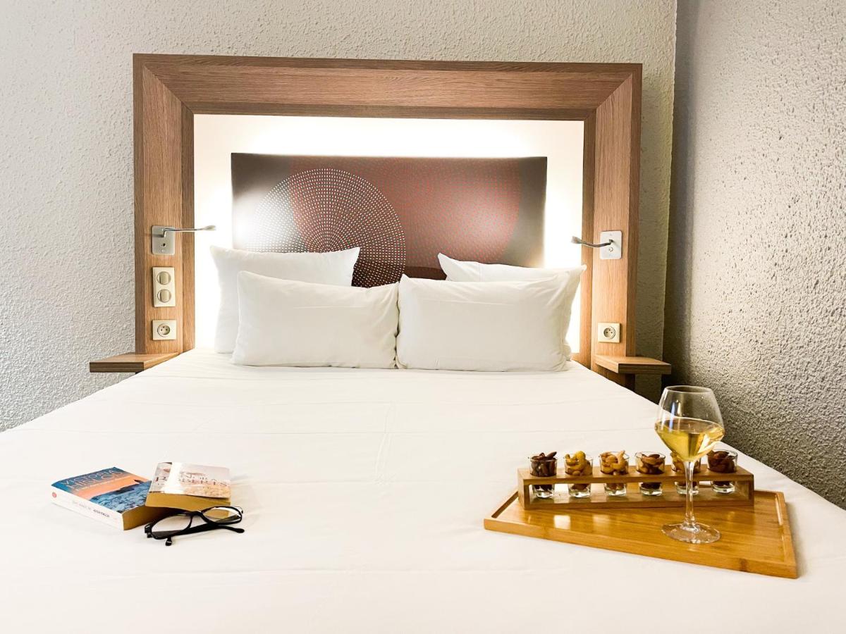 Un ou plusieurs lits dans un hébergement de l'établissement Novotel Fontainebleau Ury