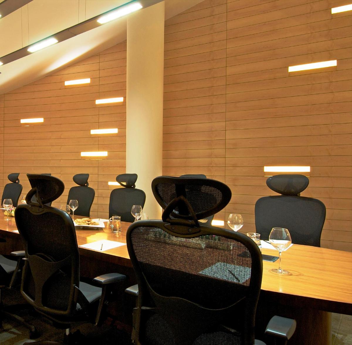 a conference room with a long table and chairs at Vivanta Bengaluru, Whitefield in Bengaluru