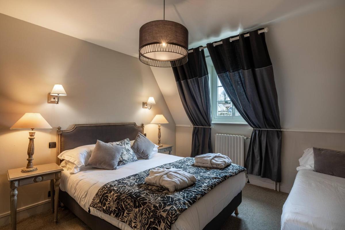 Un ou plusieurs lits dans un hébergement de l'établissement Le Bailliage Hôtel & Spa