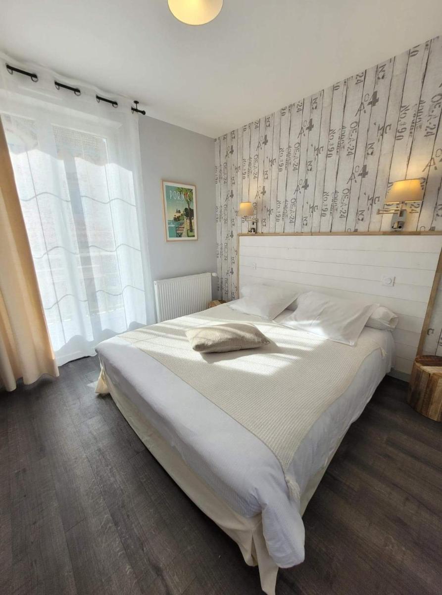 Un ou plusieurs lits dans un hébergement de l'établissement Hôtel de charme & SPA Le Grand Large