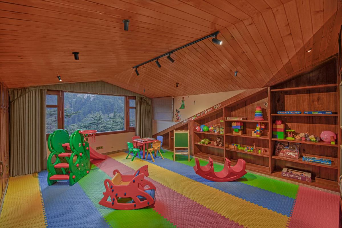 a childs room with a play area with toys in it at WelcomHeritage Elysium Resort & Spa in Shimla