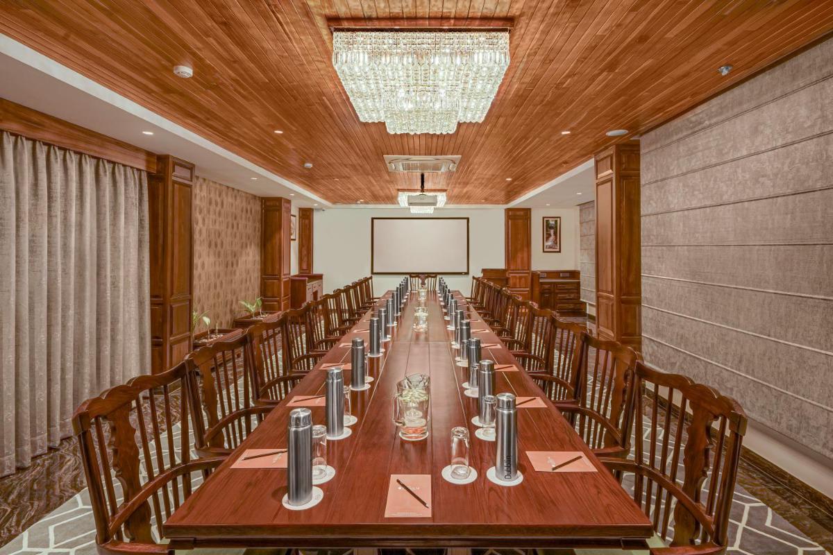 a conference room with a long table and chairs at WelcomHeritage Elysium Resort & Spa in Shimla