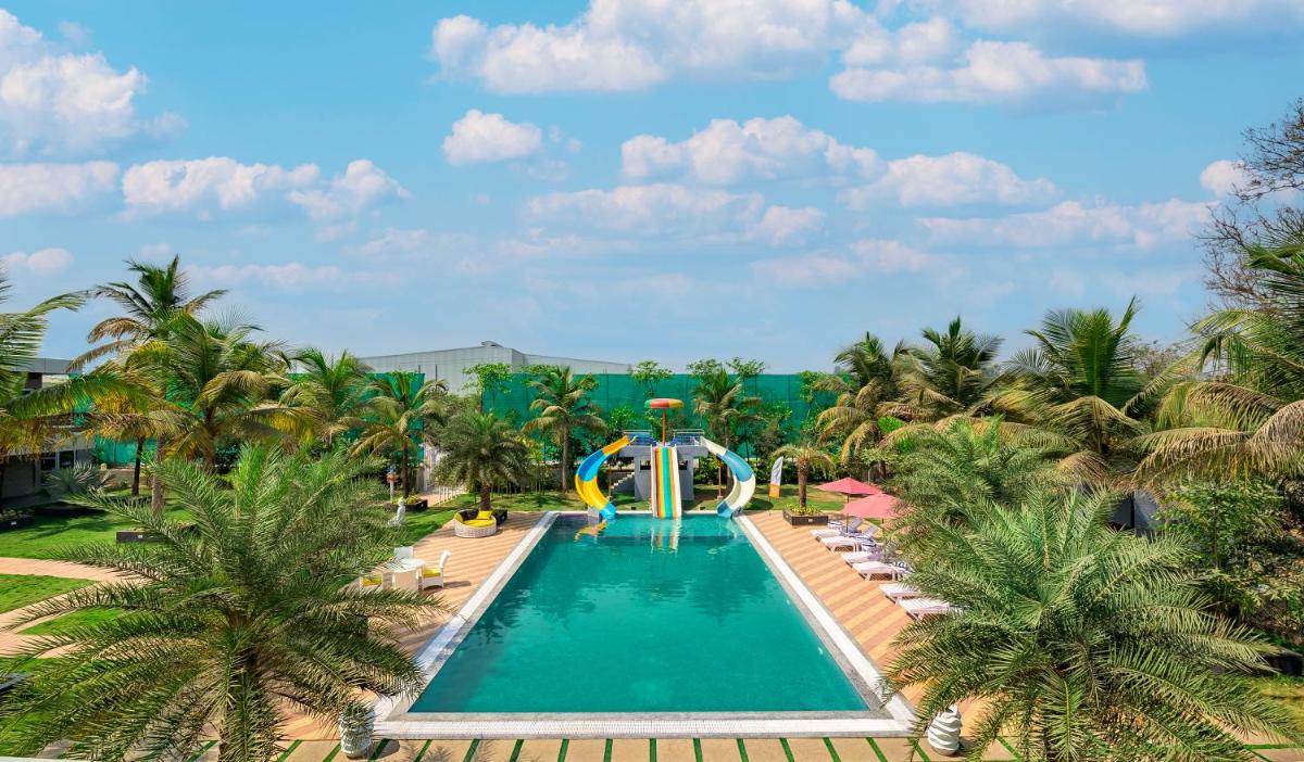 SaffronStays Palm Paradise, Kalyan Khadavli - swimming pool with water slides, gazebo and indoor games - Housity