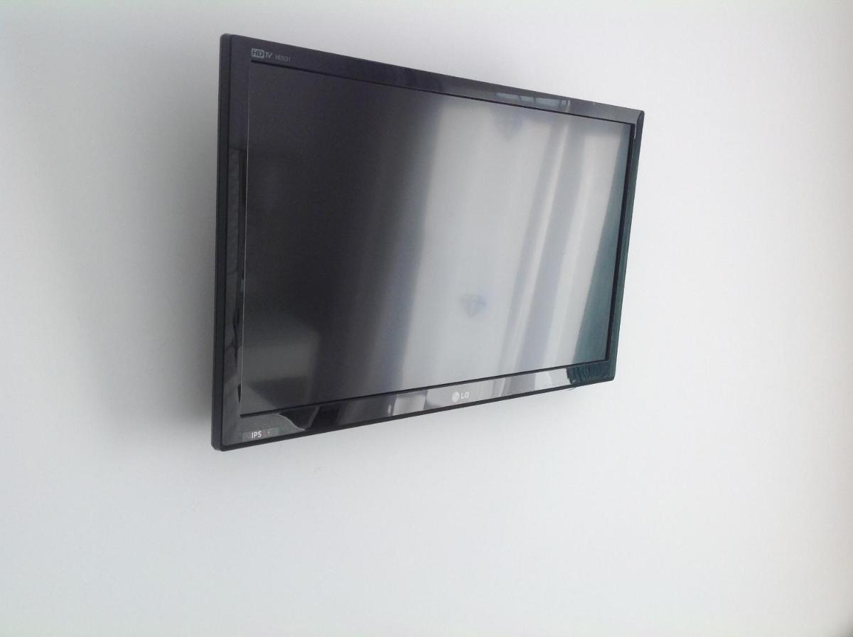 Una televisión o centro de entretenimiento en Diamant Hotel & Aparthotel