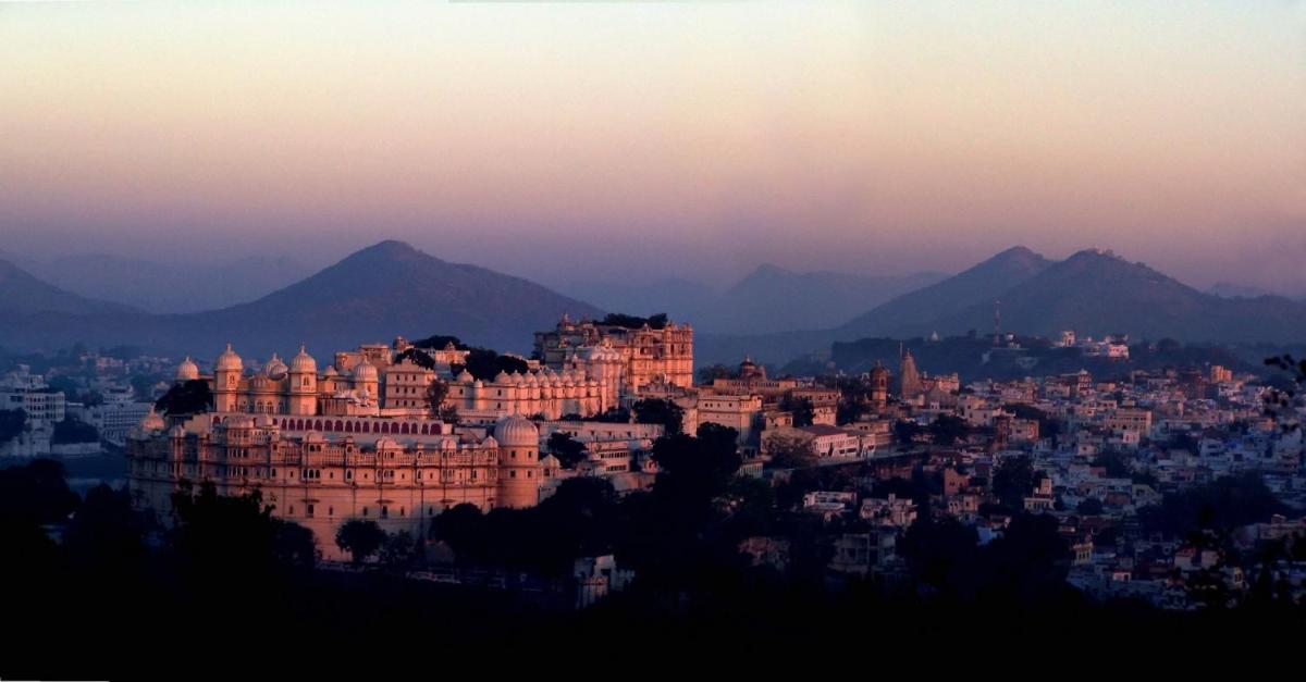 a view of a city with mountains in the background at Shiv Niwas Palace by HRH Group of Hotels in Udaipur