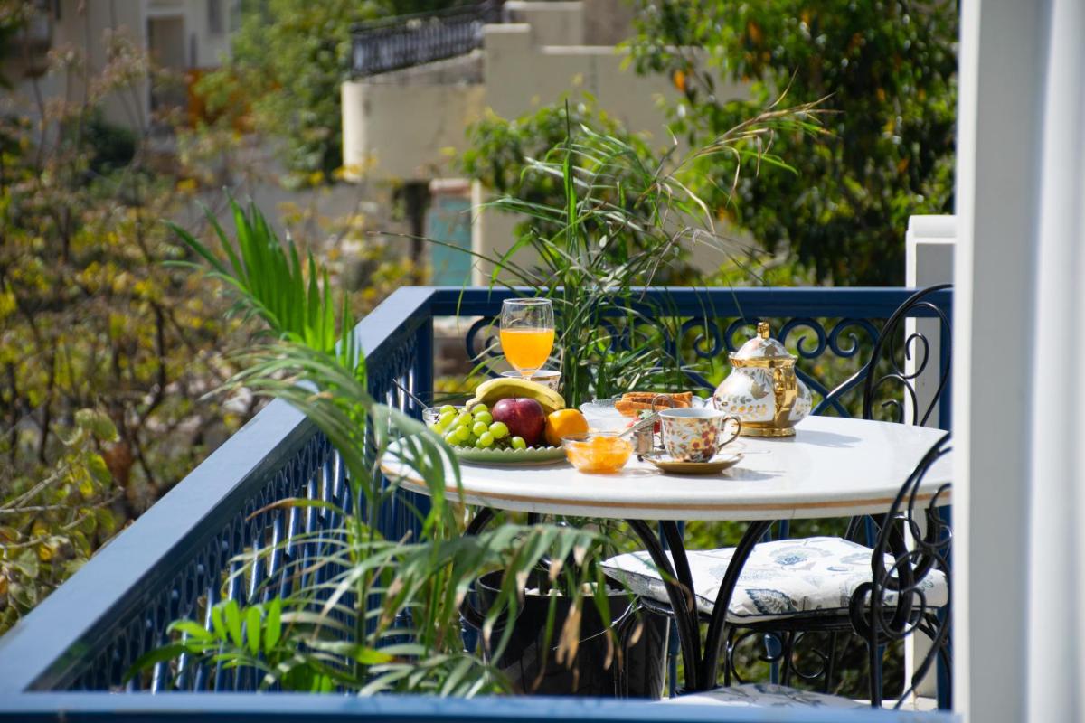 a table with a plate of fruit on a balcony at Dileep Kothi - A Royal Boutique Luxury Suites in Jaipur in Jaipur