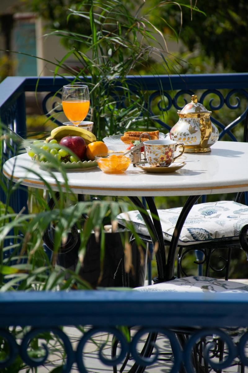 a table with a tray of fruit and juice on it at Dileep Kothi - A Royal Boutique Luxury Suites in Jaipur in Jaipur