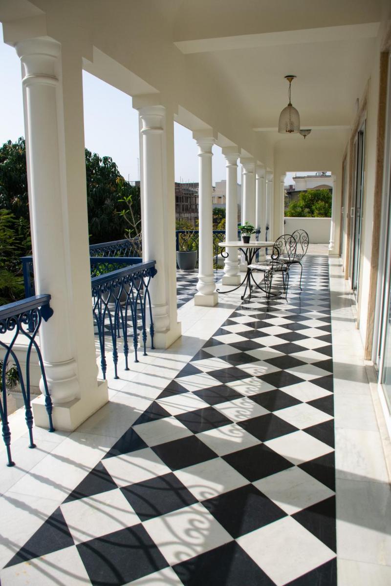 a porch with black and white checkered floor at Dileep Kothi - A Royal Boutique Luxury Suites in Jaipur in Jaipur