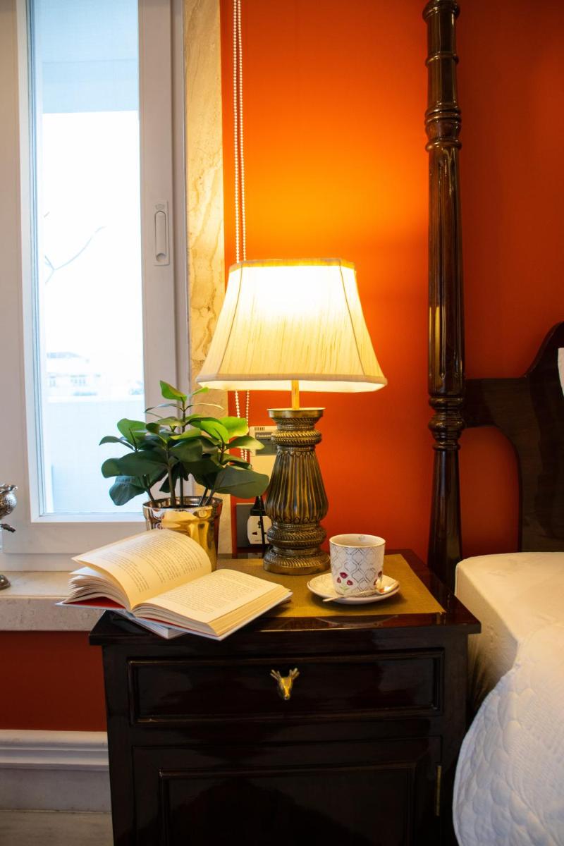 a lamp sitting on a table next to a bed at Dileep Kothi - A Royal Boutique Luxury Suites in Jaipur in Jaipur