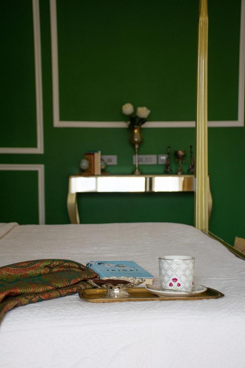 a tray with a cup and a plate on a bed at Dileep Kothi - A Royal Boutique Luxury Suites in Jaipur in Jaipur