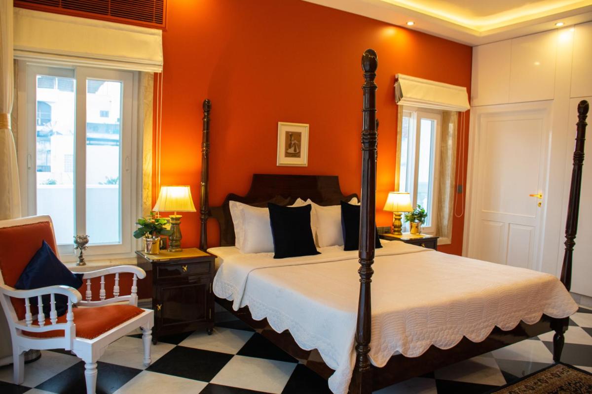 a bedroom with a bed and a chair at Dileep Kothi - A Royal Boutique Luxury Suites in Jaipur in Jaipur