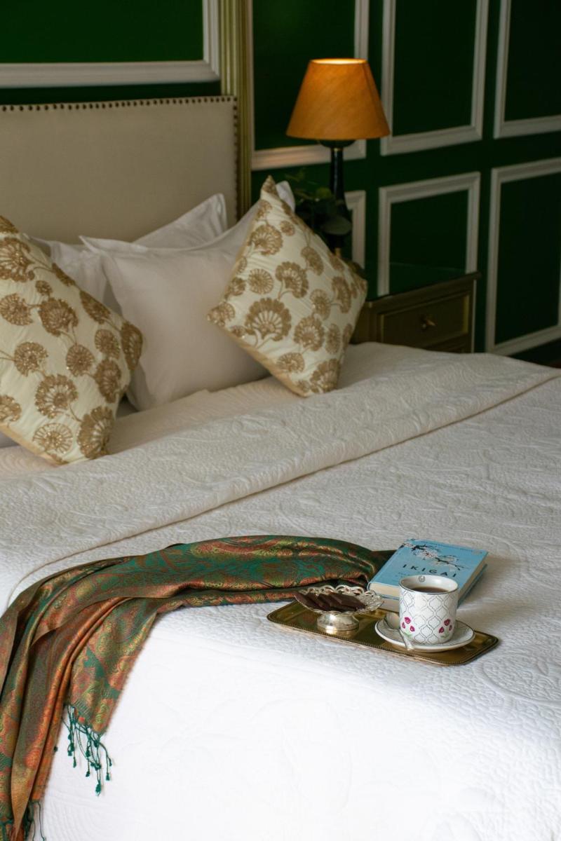 a tray with a cup and a plate on a bed at Dileep Kothi - A Royal Boutique Luxury Suites in Jaipur in Jaipur