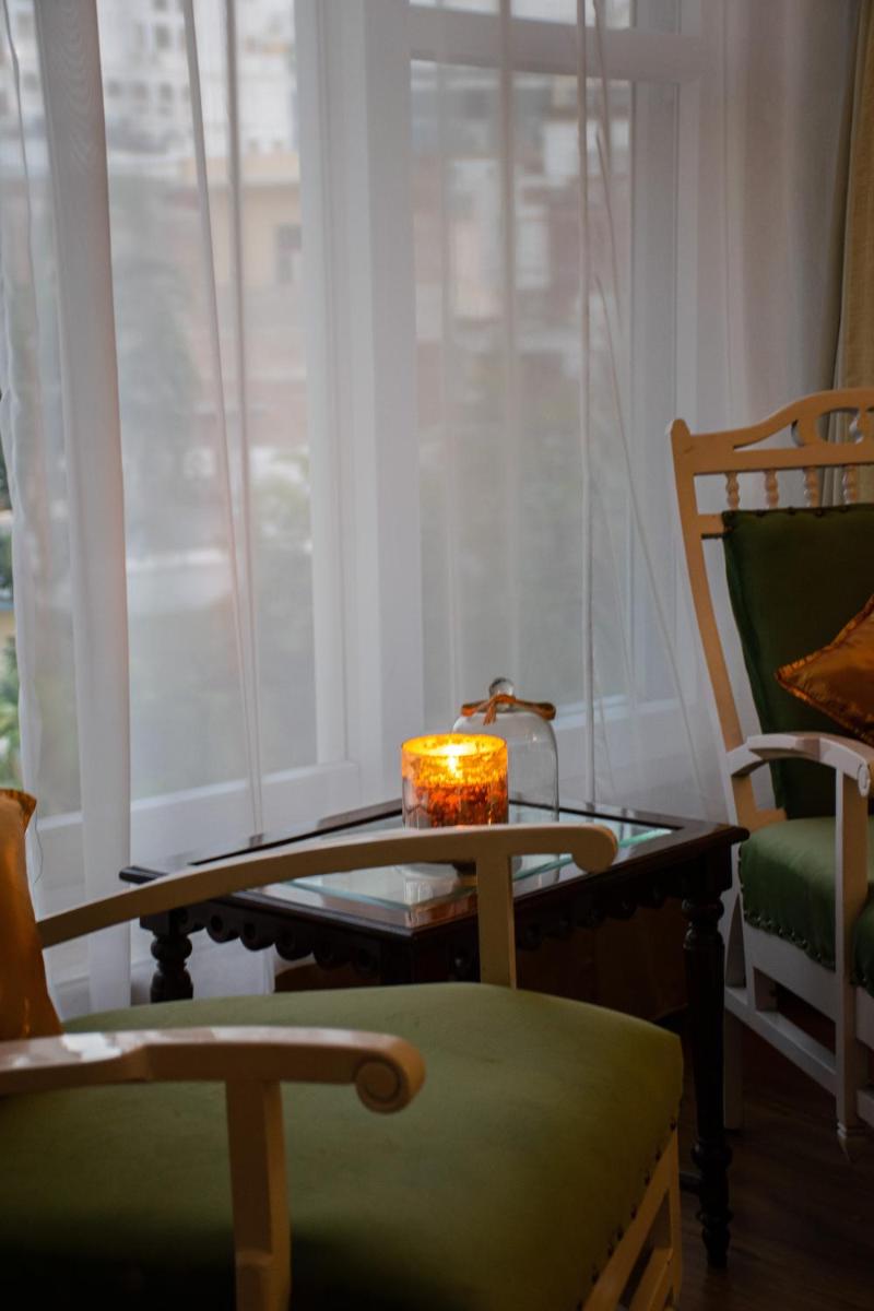 a candle sitting on a table in front of a window at Dileep Kothi - A Royal Boutique Luxury Suites in Jaipur in Jaipur