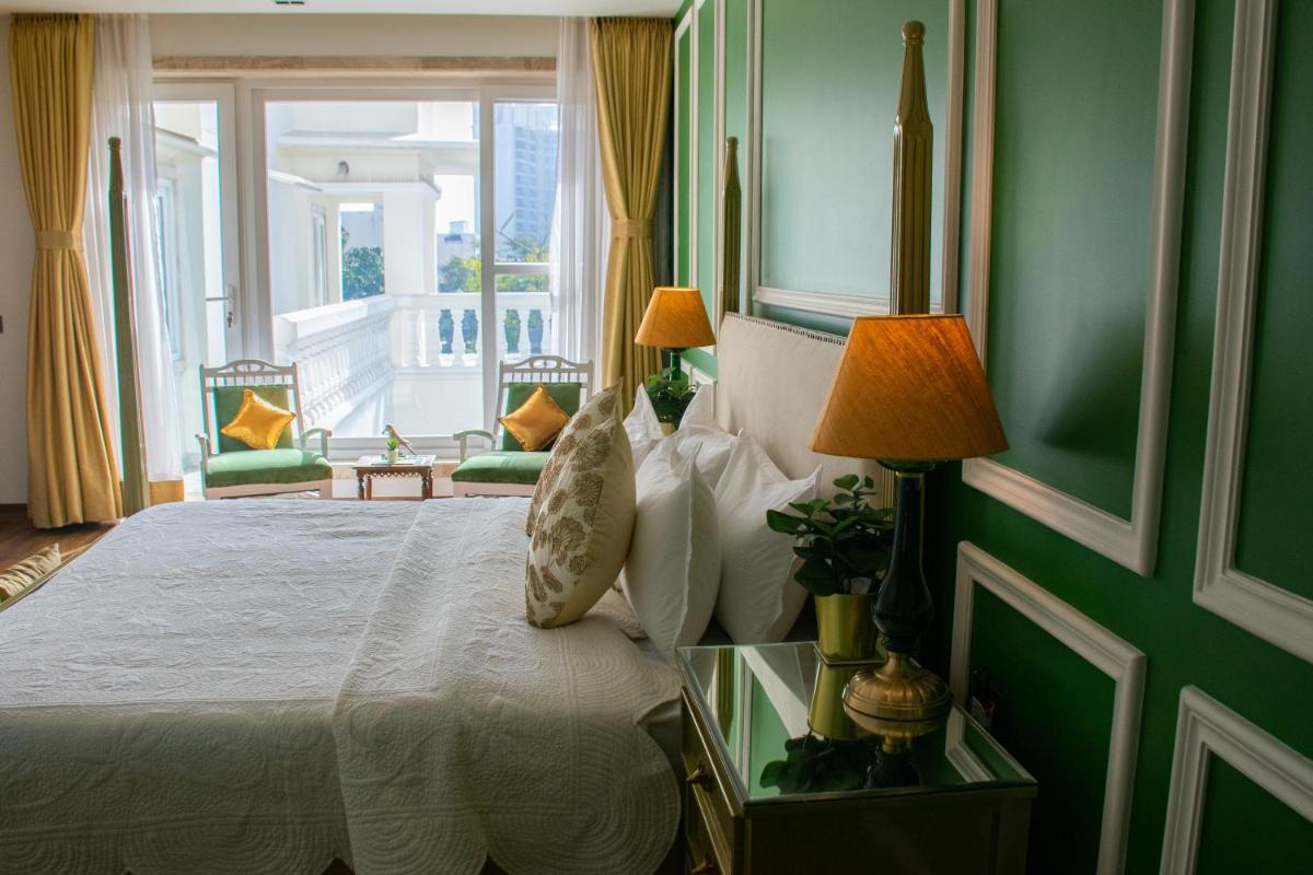 a bedroom with a bed and a window with a view at Dileep Kothi - A Royal Boutique Luxury Suites in Jaipur in Jaipur