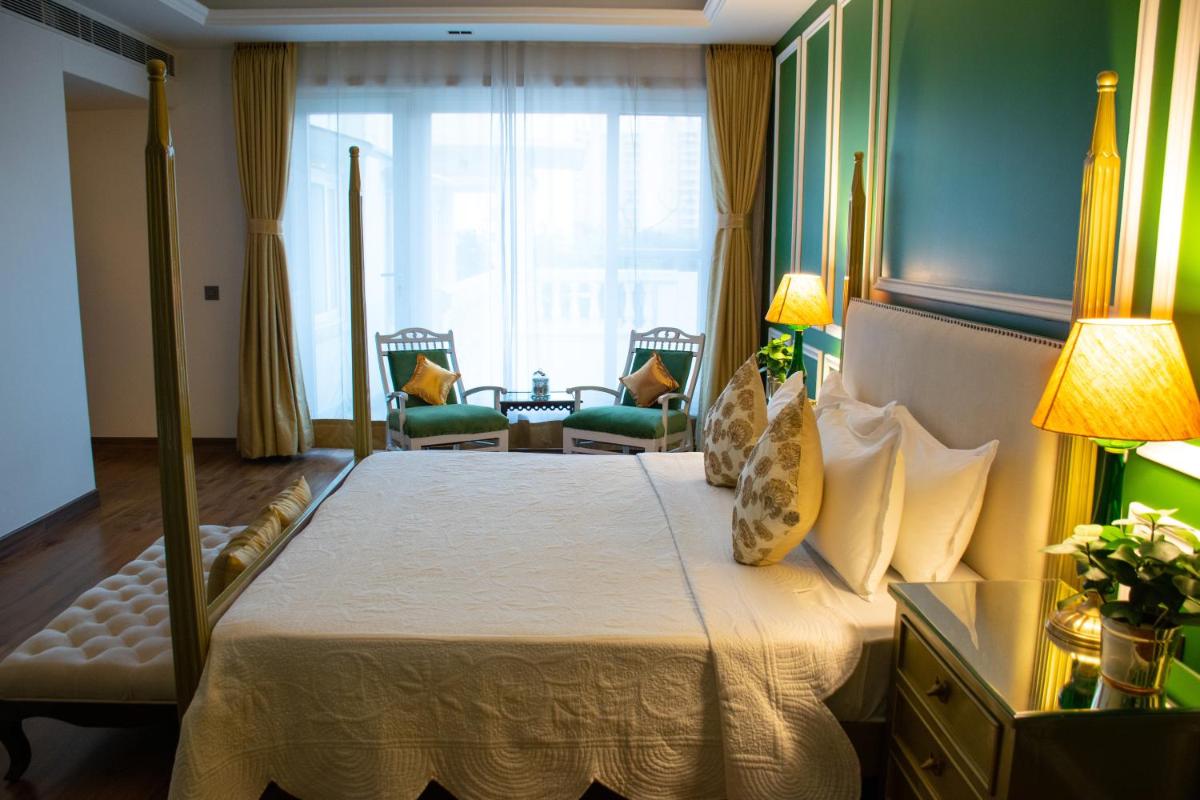 a bedroom with a large bed with a large window at Dileep Kothi - A Royal Boutique Luxury Suites in Jaipur in Jaipur