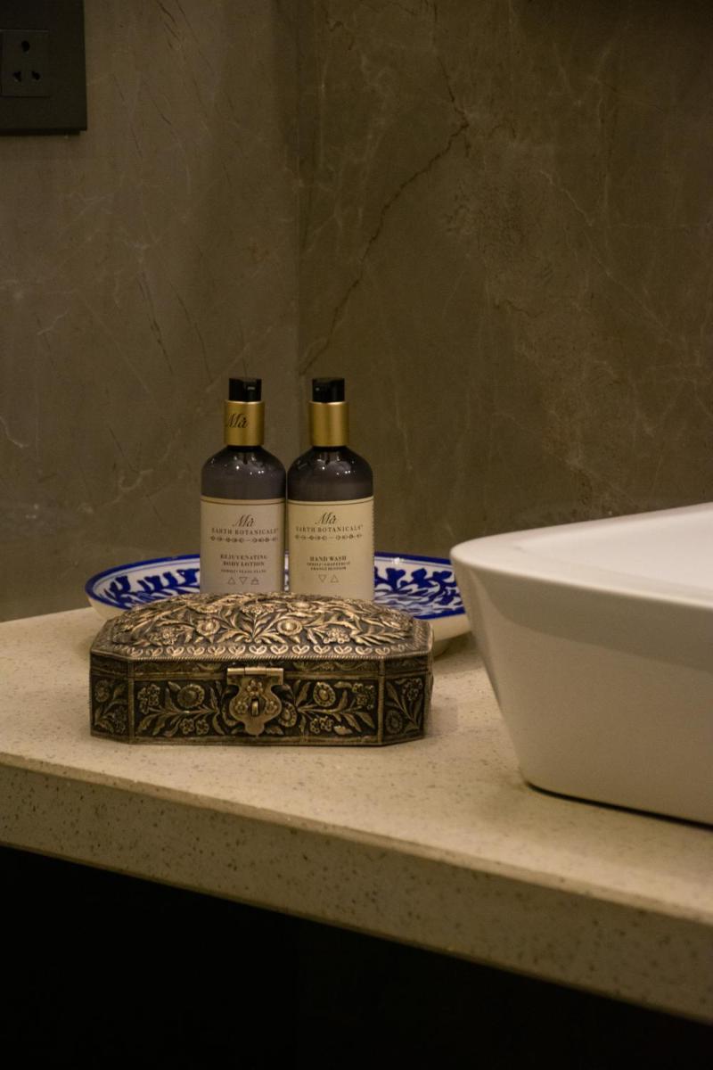 two bottles of wine sitting on a counter next to a sink at Dileep Kothi - A Royal Boutique Luxury Suites in Jaipur in Jaipur