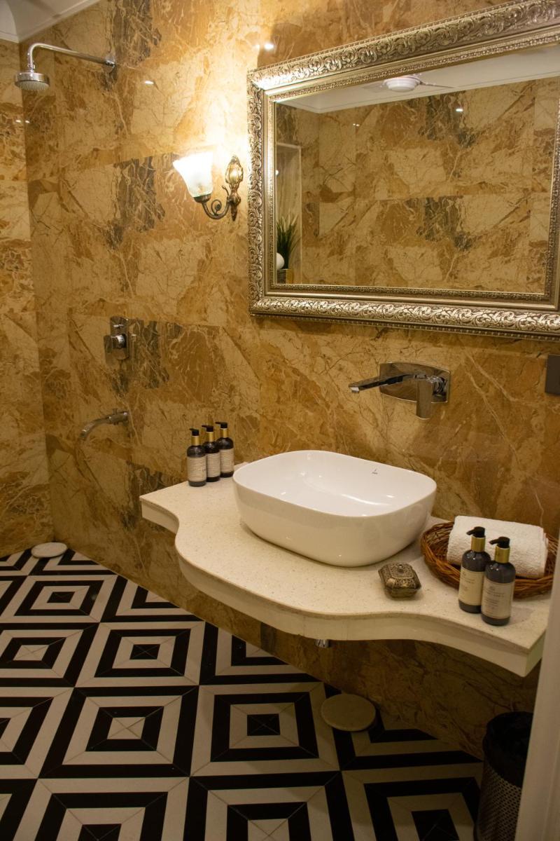 a bathroom with a sink and a mirror at Dileep Kothi - A Royal Boutique Luxury Suites in Jaipur in Jaipur