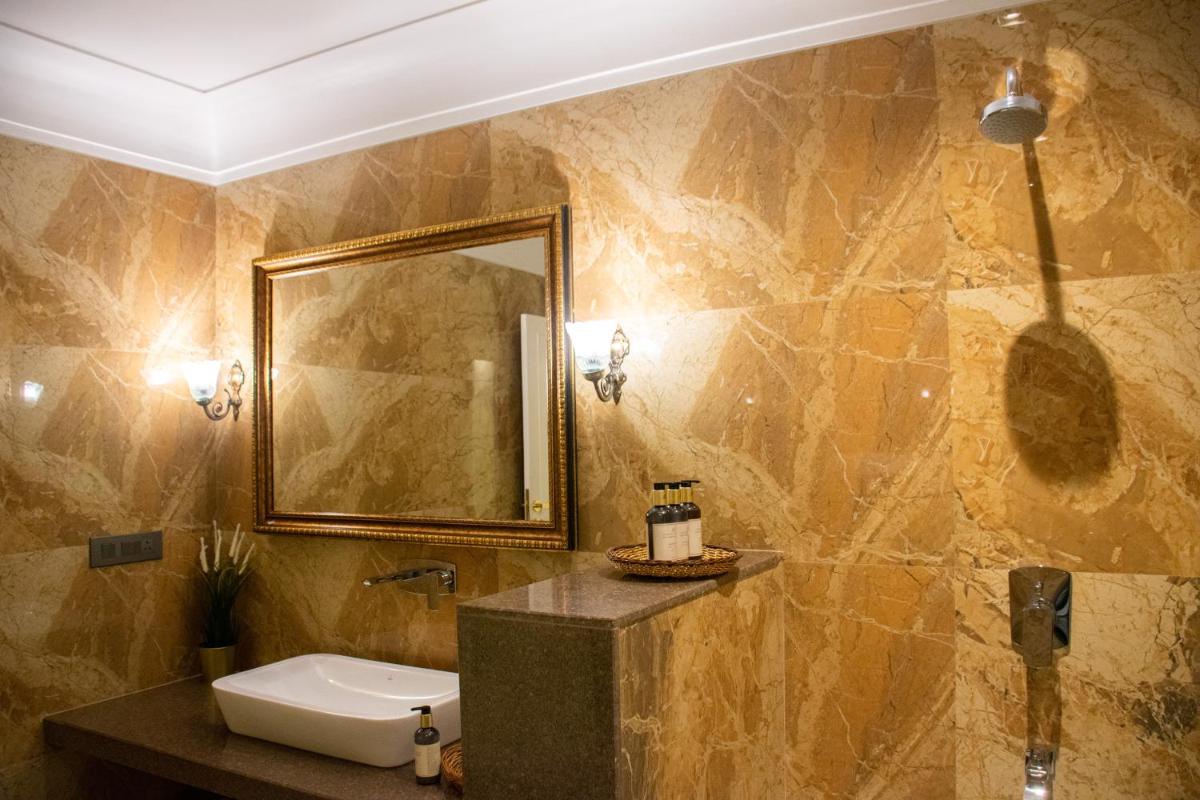 a bathroom with a sink and a mirror at Dileep Kothi - A Royal Boutique Luxury Suites in Jaipur in Jaipur