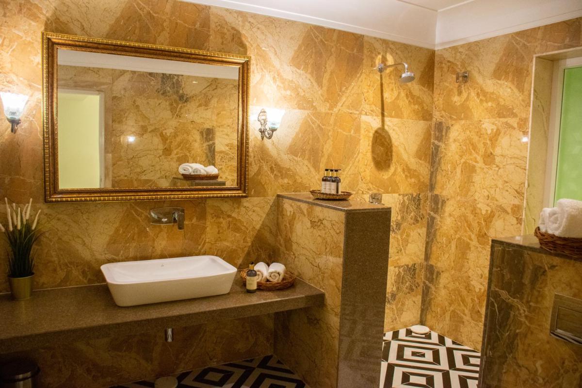 a bathroom with a sink and a mirror at Dileep Kothi - A Royal Boutique Luxury Suites in Jaipur in Jaipur