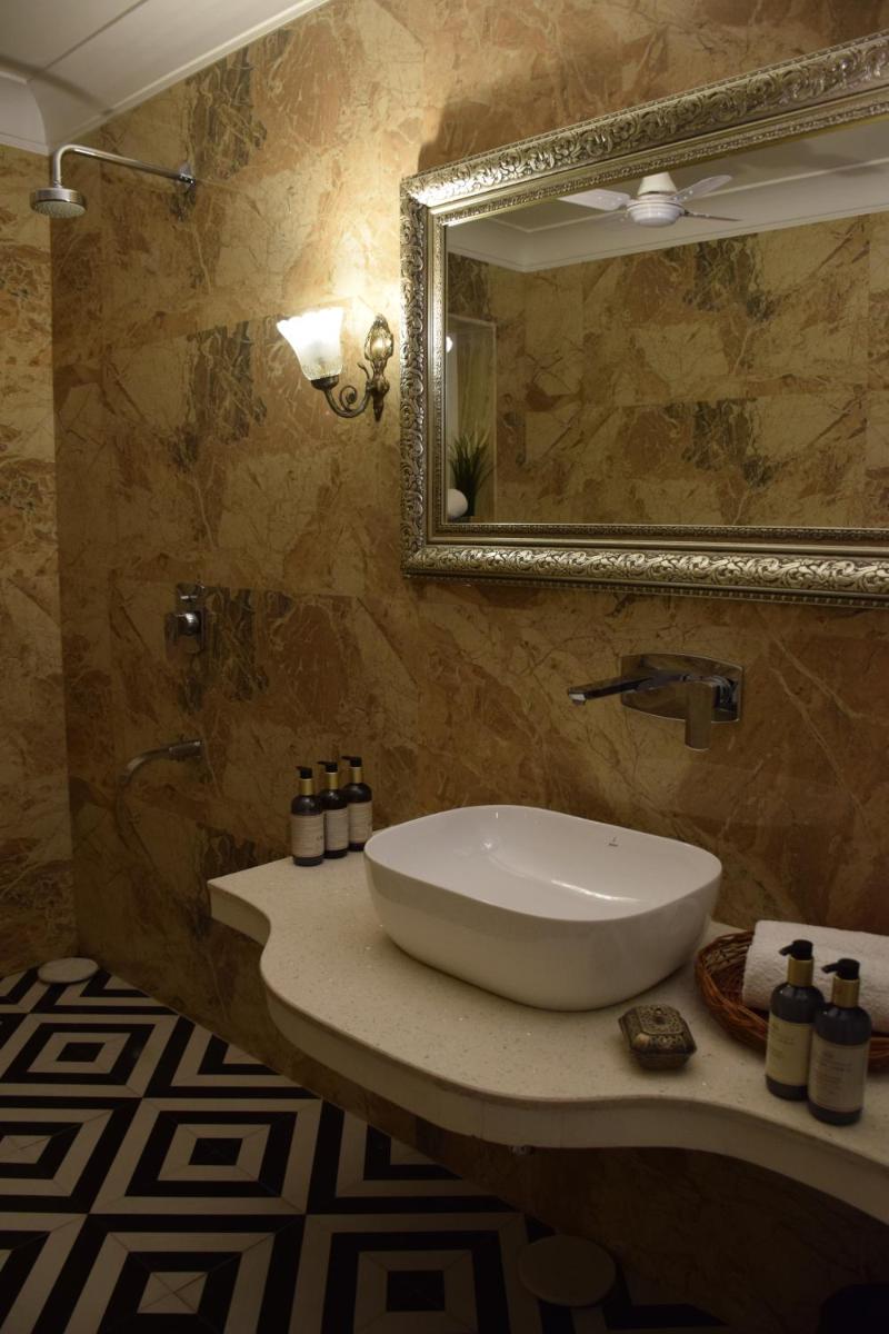 a bathroom with a sink and a mirror at Dileep Kothi - A Royal Boutique Luxury Suites in Jaipur in Jaipur