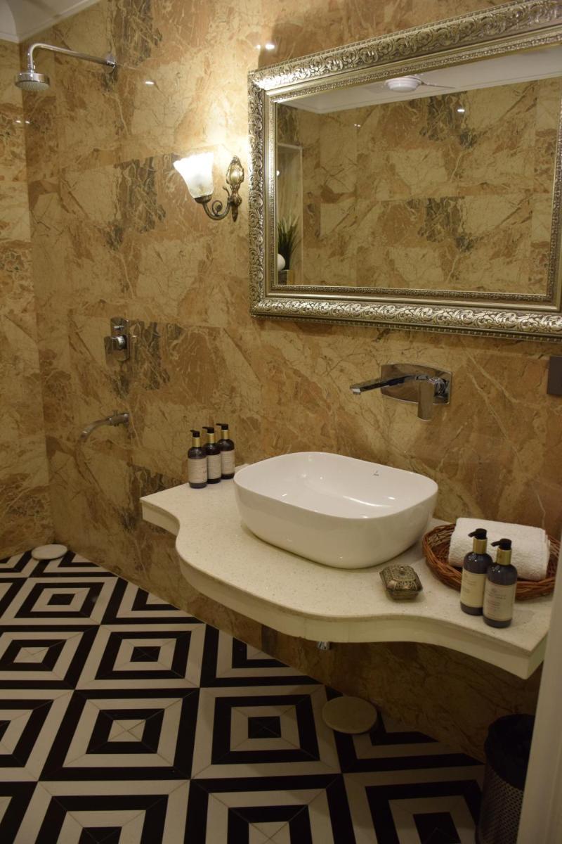 a bathroom with a sink and a mirror at Dileep Kothi - A Royal Boutique Luxury Suites in Jaipur in Jaipur