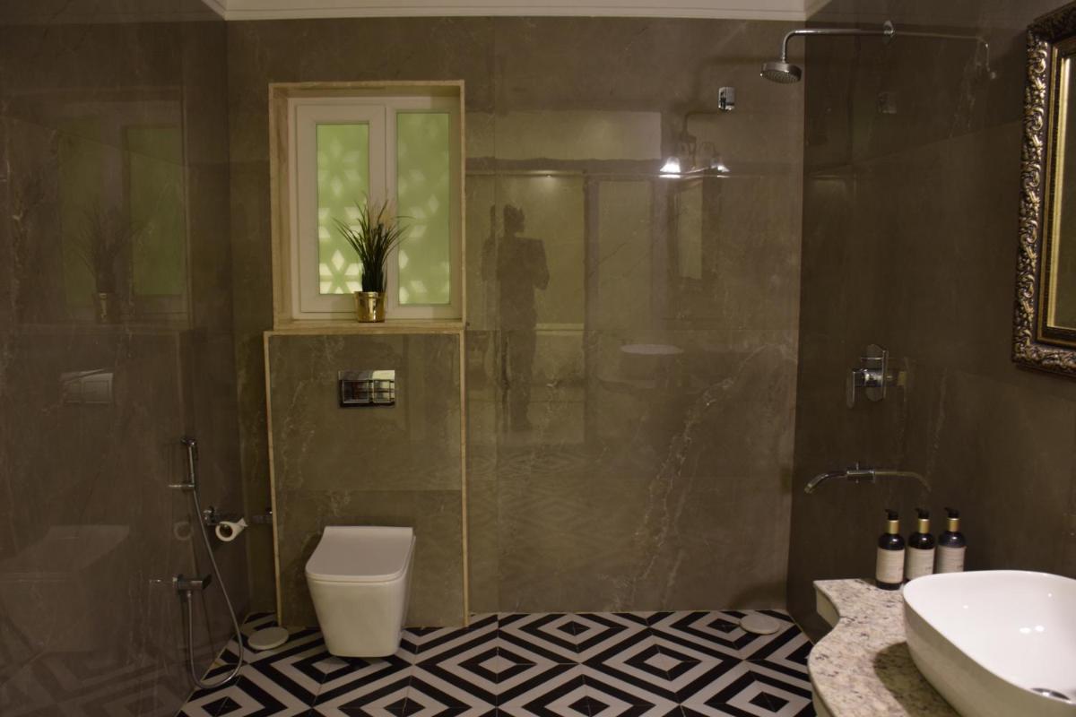a bathroom with a shower and a toilet and a sink at Dileep Kothi - A Royal Boutique Luxury Suites in Jaipur in Jaipur