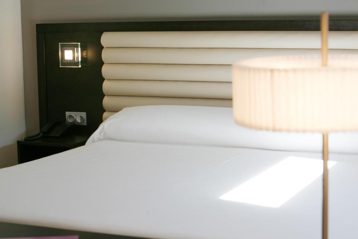 Cama o camas de una habitación en Hotel Bienestar Moaña