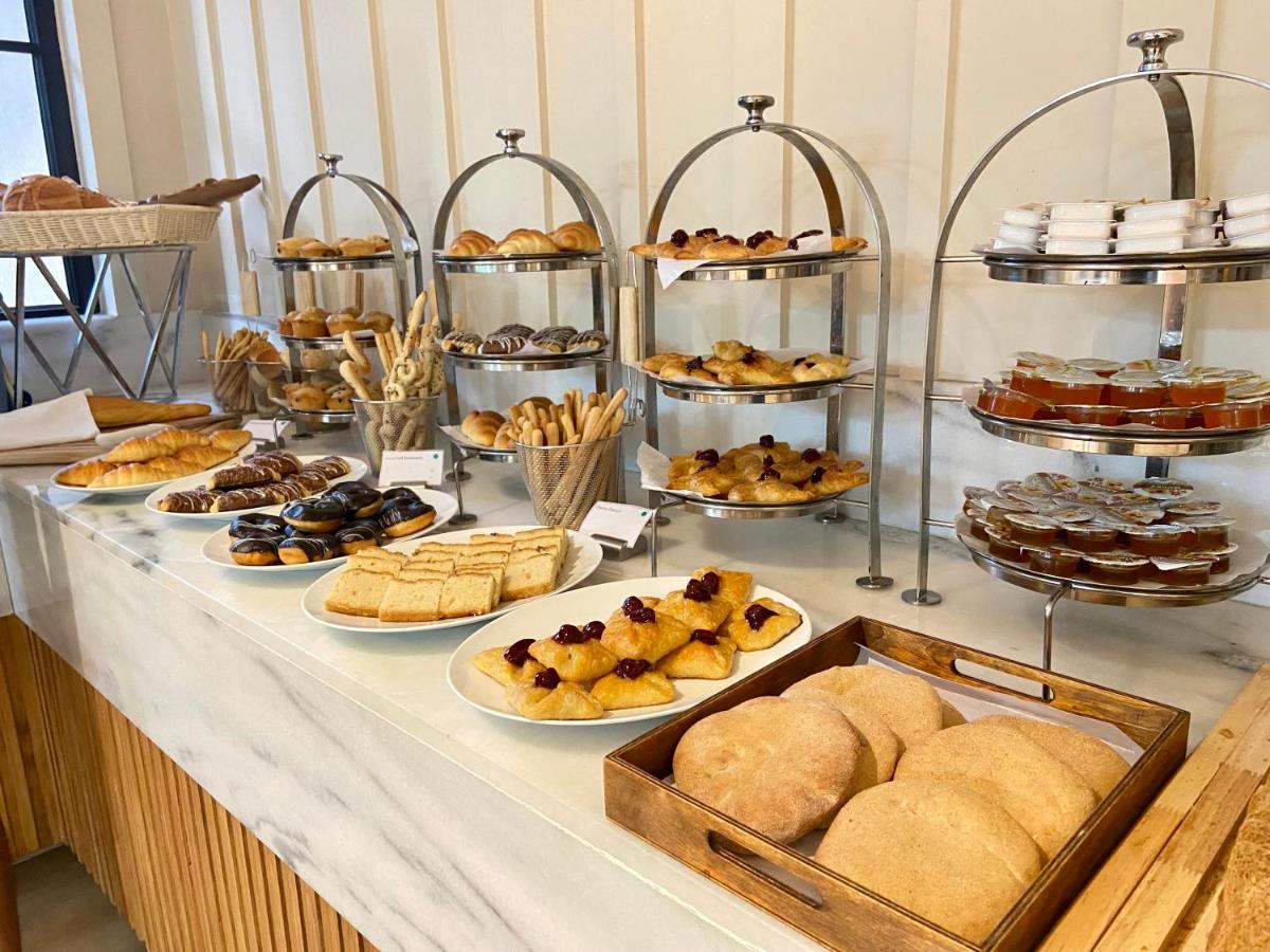 a buffet of pastries and desserts on a table at Holiday Inn Goa Candolim in Candolim a buffet of pastries and desserts on a table at Holiday Inn Goa Candolim in Candolim