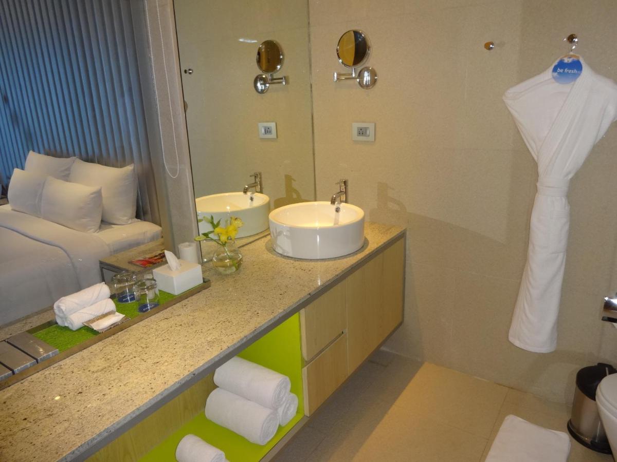 a bathroom with a sink and a mirror at Avasa Hotel in Hyderabad