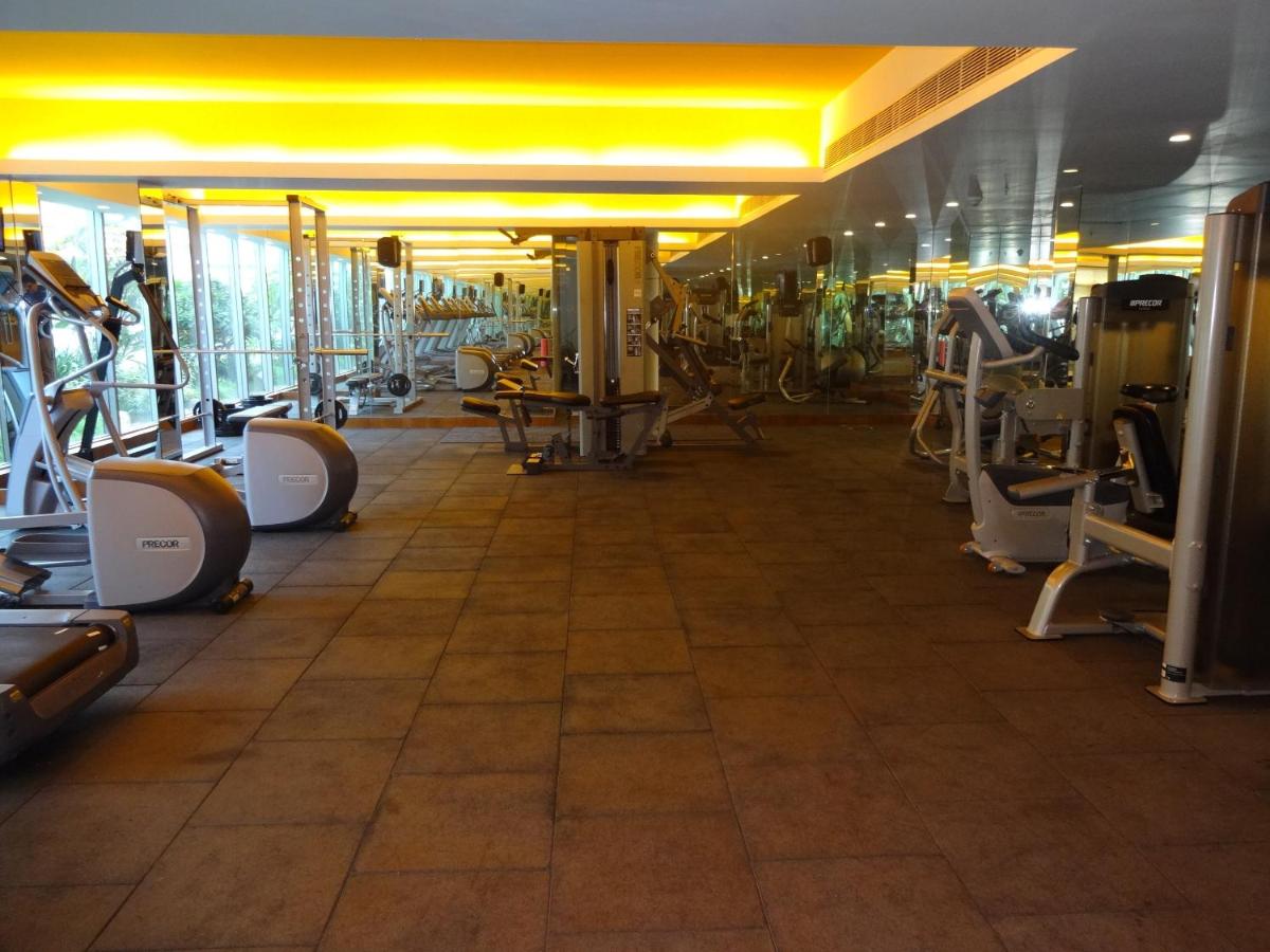 a gym with several rows of exercise machines at Avasa Hotel in Hyderabad