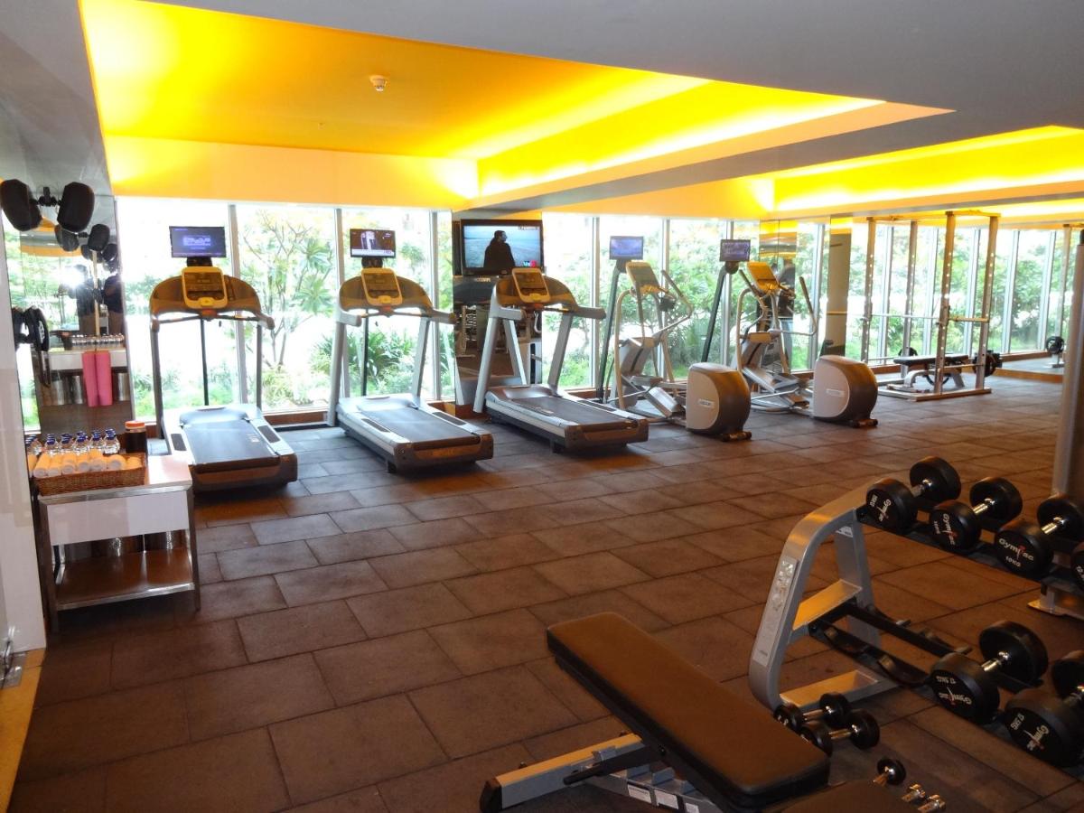 a gym with a bunch of exercise bikes in a room at Avasa Hotel in Hyderabad