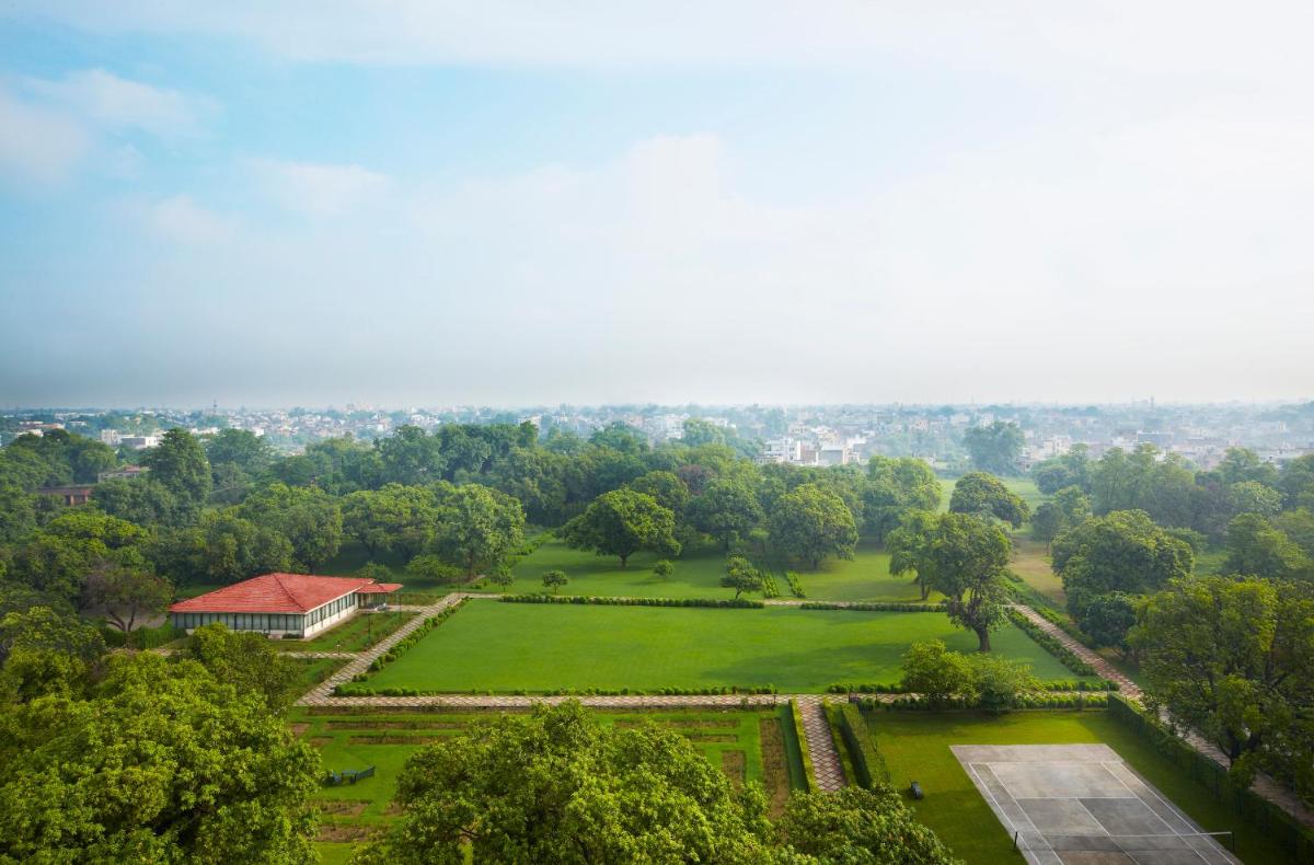 an aerial view of a park with a building and trees at Taj Ganges Varanasi in Varanasi