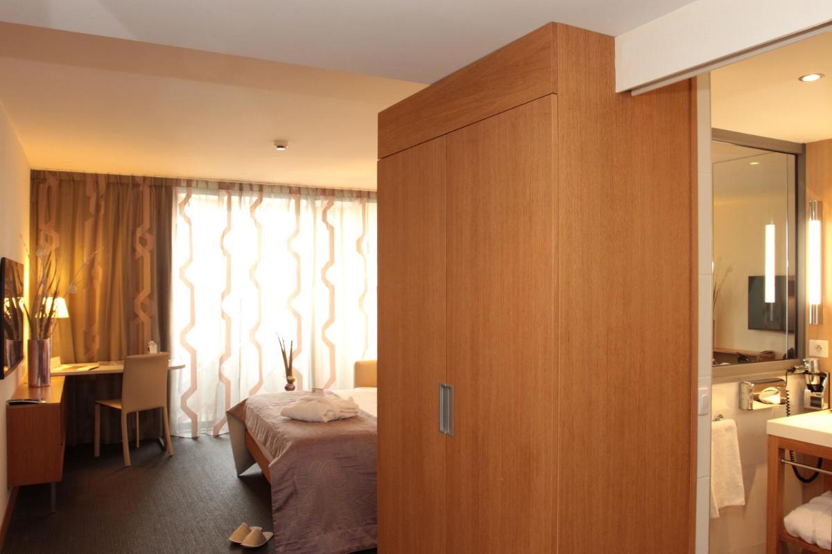 Un ou plusieurs lits dans un hébergement de l'établissement Best Western Premier Hôtel du Vieux-Port