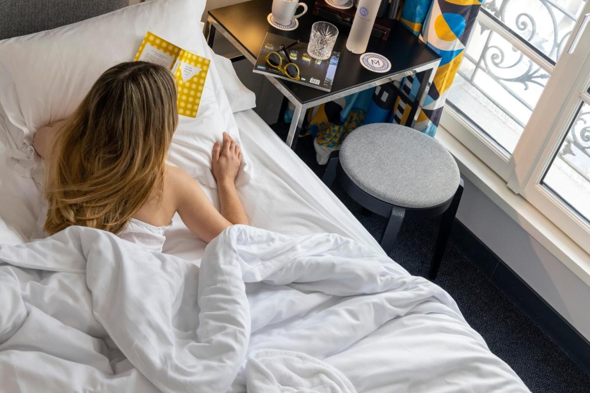 Un ou plusieurs lits dans un hébergement de l'établissement Les Matins de Paris & Spa