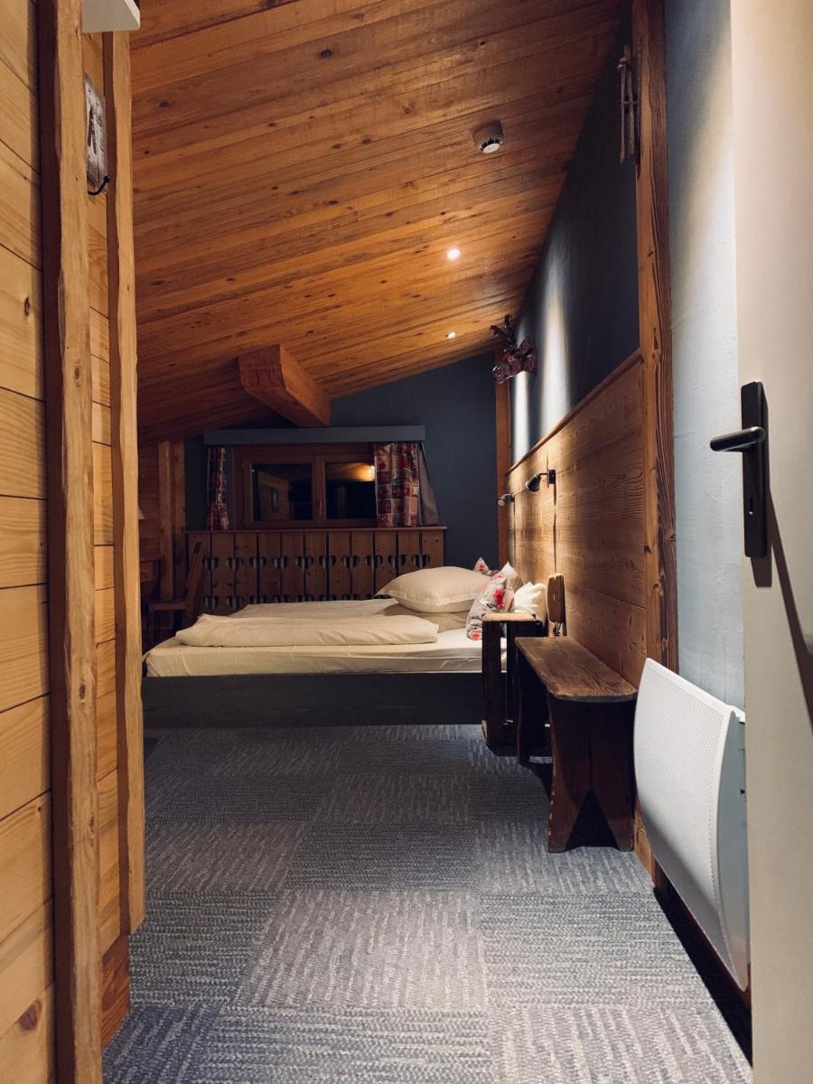 Un ou plusieurs lits dans un hébergement de l'établissement Chalet Hôtel & Spa Le Collet