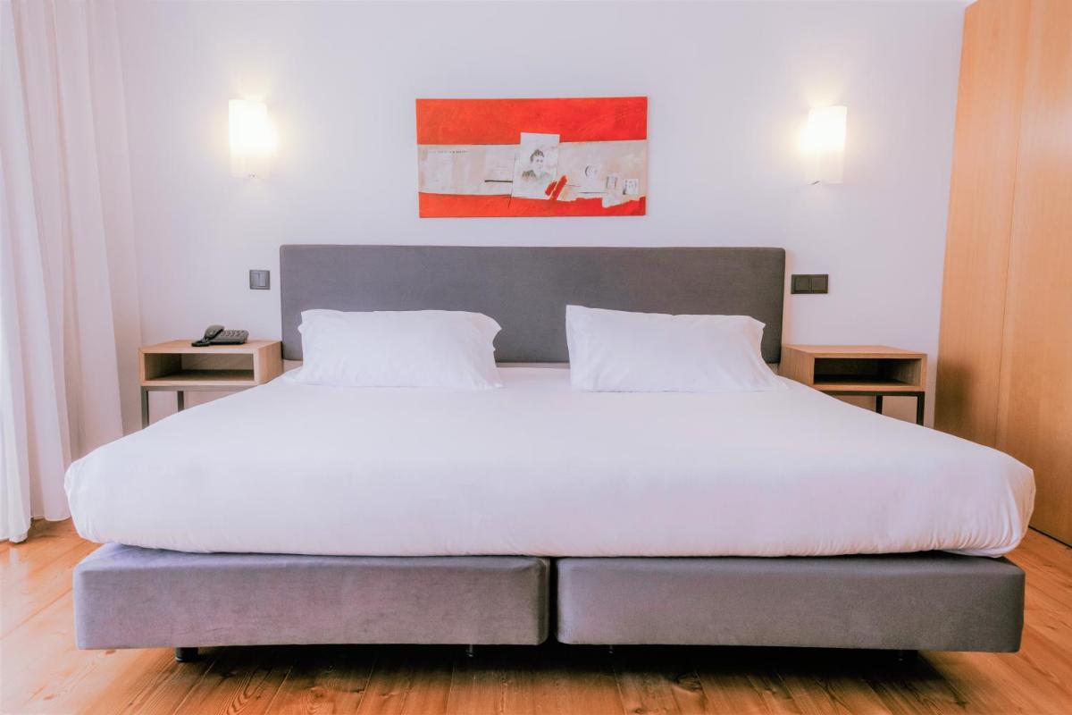 Uma cama ou camas num quarto em Monte Prado Hotel & Spa