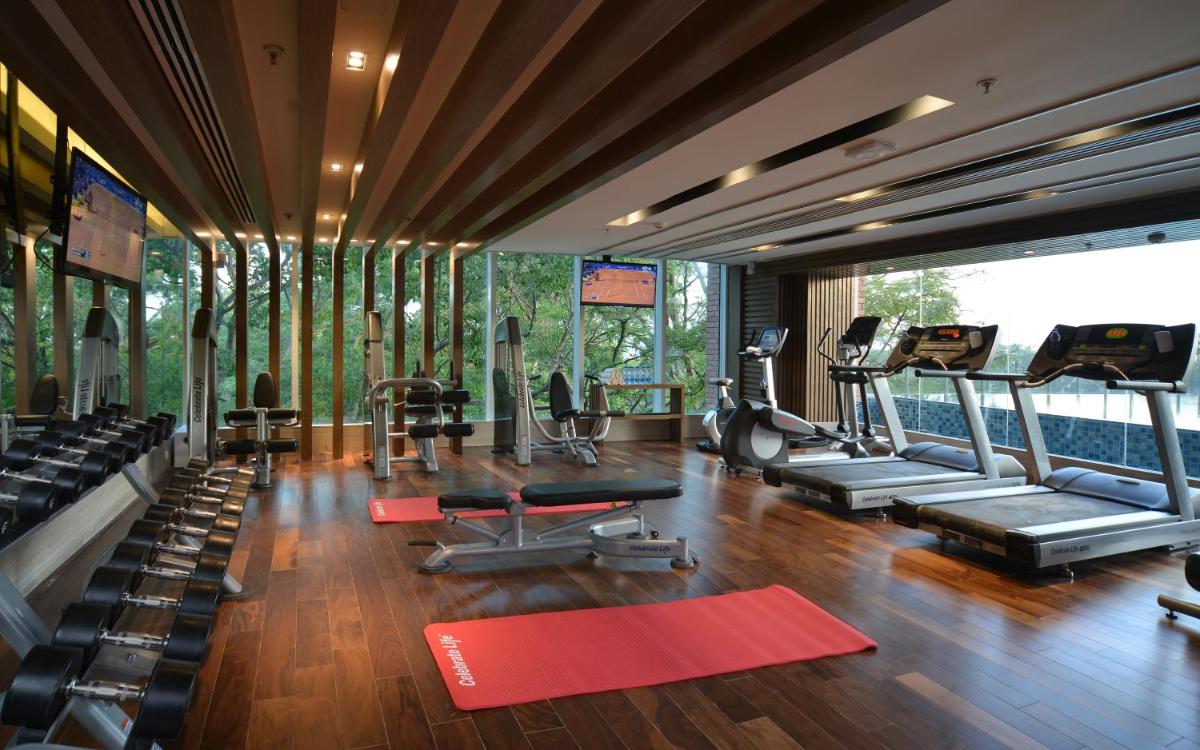a gym with treadmills and machines in a room at Welcomhotel by ITC Hotels, Richmond Road, Bengaluru in Bengaluru