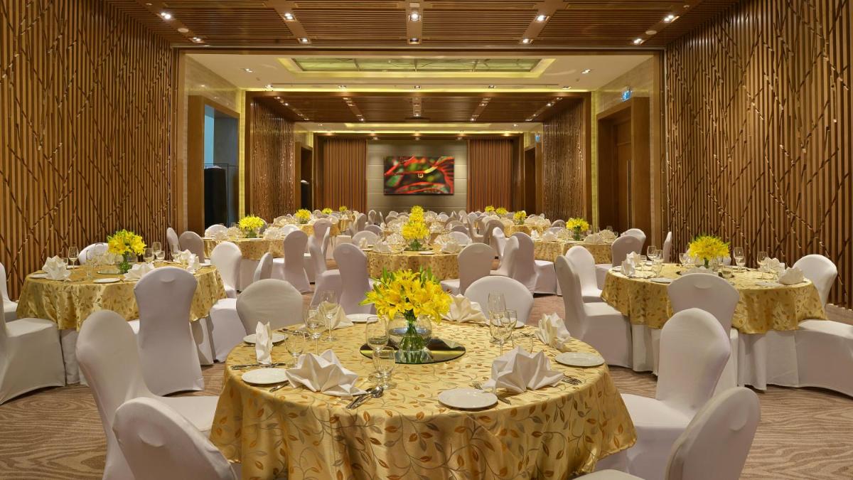 a banquet hall with tables and white chairs at Welcomhotel by ITC Hotels, Richmond Road, Bengaluru in Bengaluru
