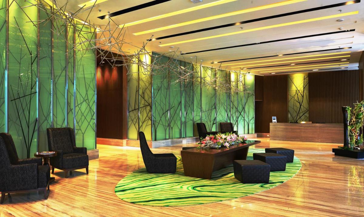 a lobby with chairs and a green wall at Welcomhotel by ITC Hotels, Richmond Road, Bengaluru in Bengaluru