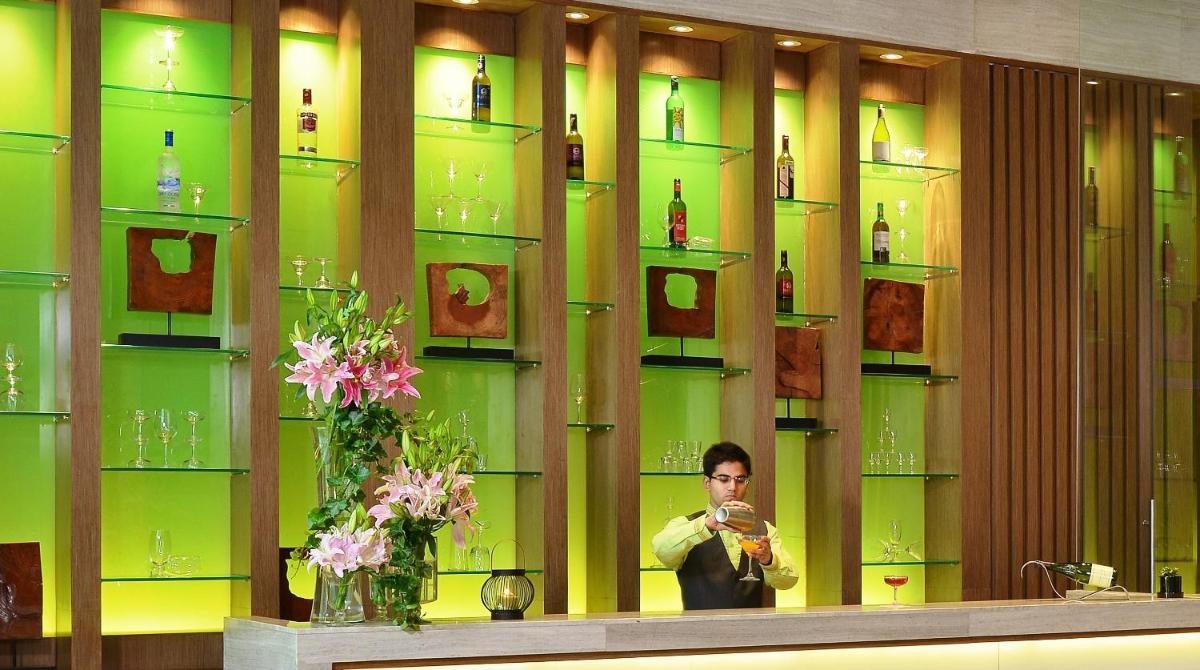 a man taking a picture of himself in a mirror at Welcomhotel by ITC Hotels, Richmond Road, Bengaluru in Bengaluru