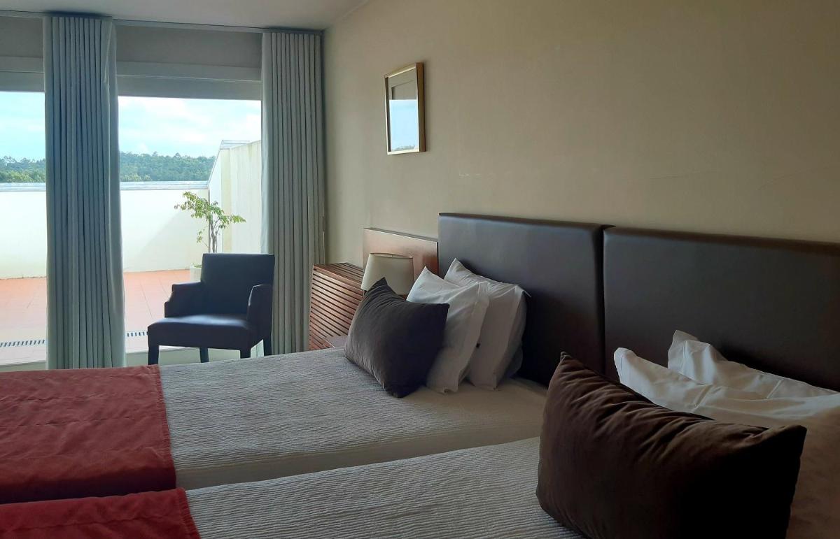 Uma cama ou camas num quarto em Santana Hotel & SPA