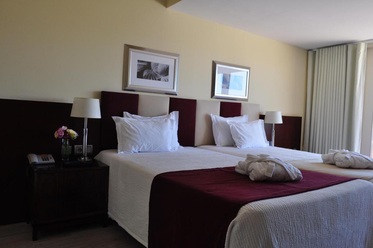 Uma cama ou camas num quarto em Santana Hotel & SPA